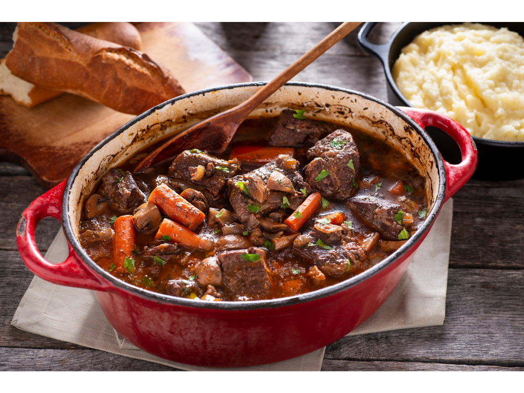 a red pot with meat and vegetables