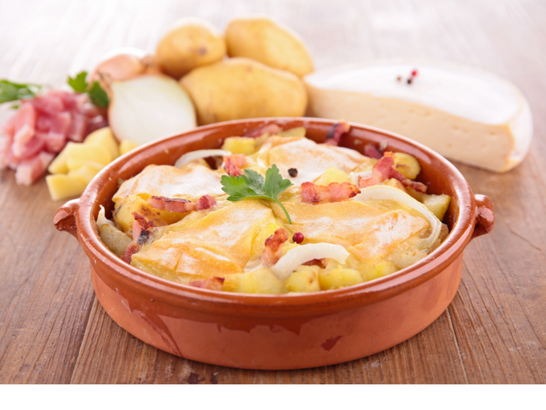 a bowl of food next to potatoes and cheese